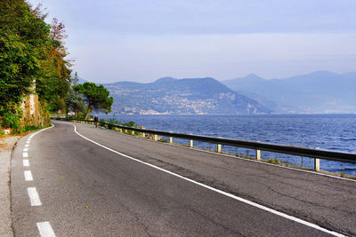 Road by sea against sky