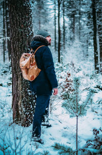 Full length of woman in forest during winter