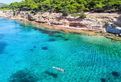 High angle view of woman snorkeling in sea on sunny day