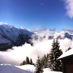 Scenic view of snow covered mountains against sky