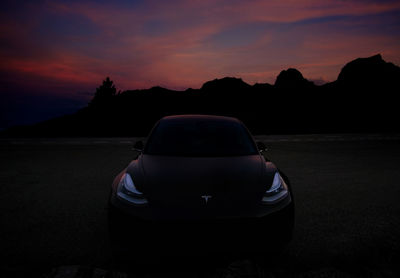 Silhouette car against sky during sunset