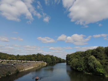 River amidst trees against sky