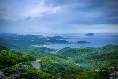 High angle view of landscape and sea against sky