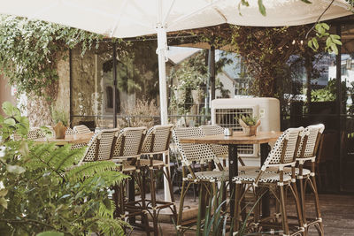 Empty chairs and tables in restaurant