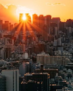 Aerial view of buildings in city during sunset