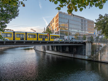Bridge over river against sky during sunset