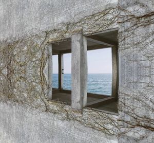 Building by sea against sky