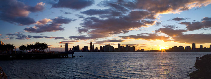 Scenic view of silhouette buildings against sky during sunset