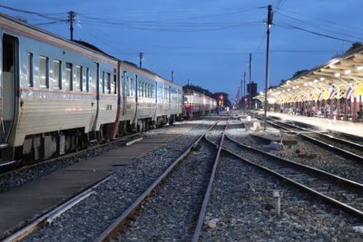 Train on railroad tracks against blue sky