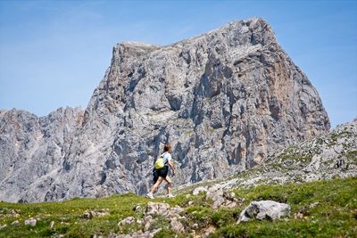 A woman goes hiking in the mountains