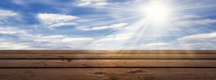 Low angle view of wood against sky