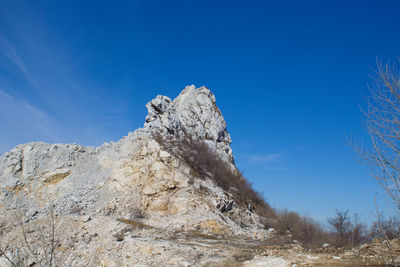 Low angle view of rock formation against sky