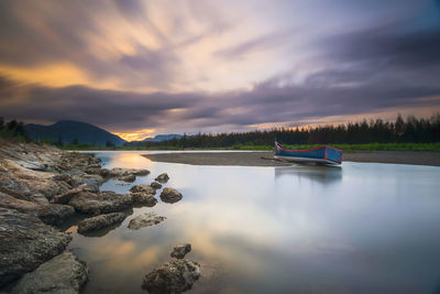 Scenic view of lake against sky during sunset