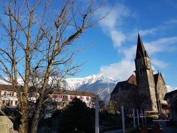 Panoramic view of trees and buildings against sky