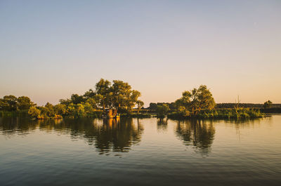 Scenic view of lake against sky during sunset