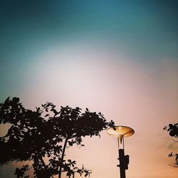 Low angle view of street light against sky at sunset