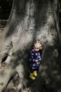 Girl in tree trunk