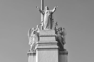 Low angle view of statues against sky