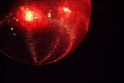 Close-up of illuminated lighting equipment against black background