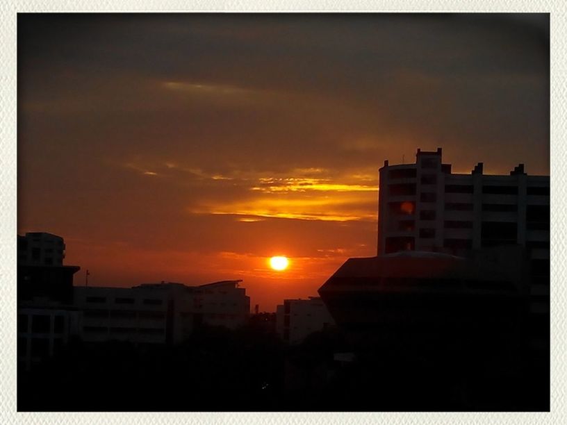 sunset, building exterior, architecture, built structure, sun, orange color, transfer print, silhouette, sky, auto post production filter, residential structure, sunlight, city, house, residential building, building, cloud - sky, low angle view, outdoors, cloud