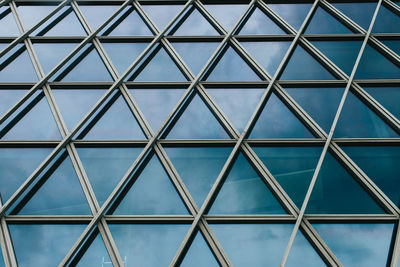Full frame shot of glass building against sky