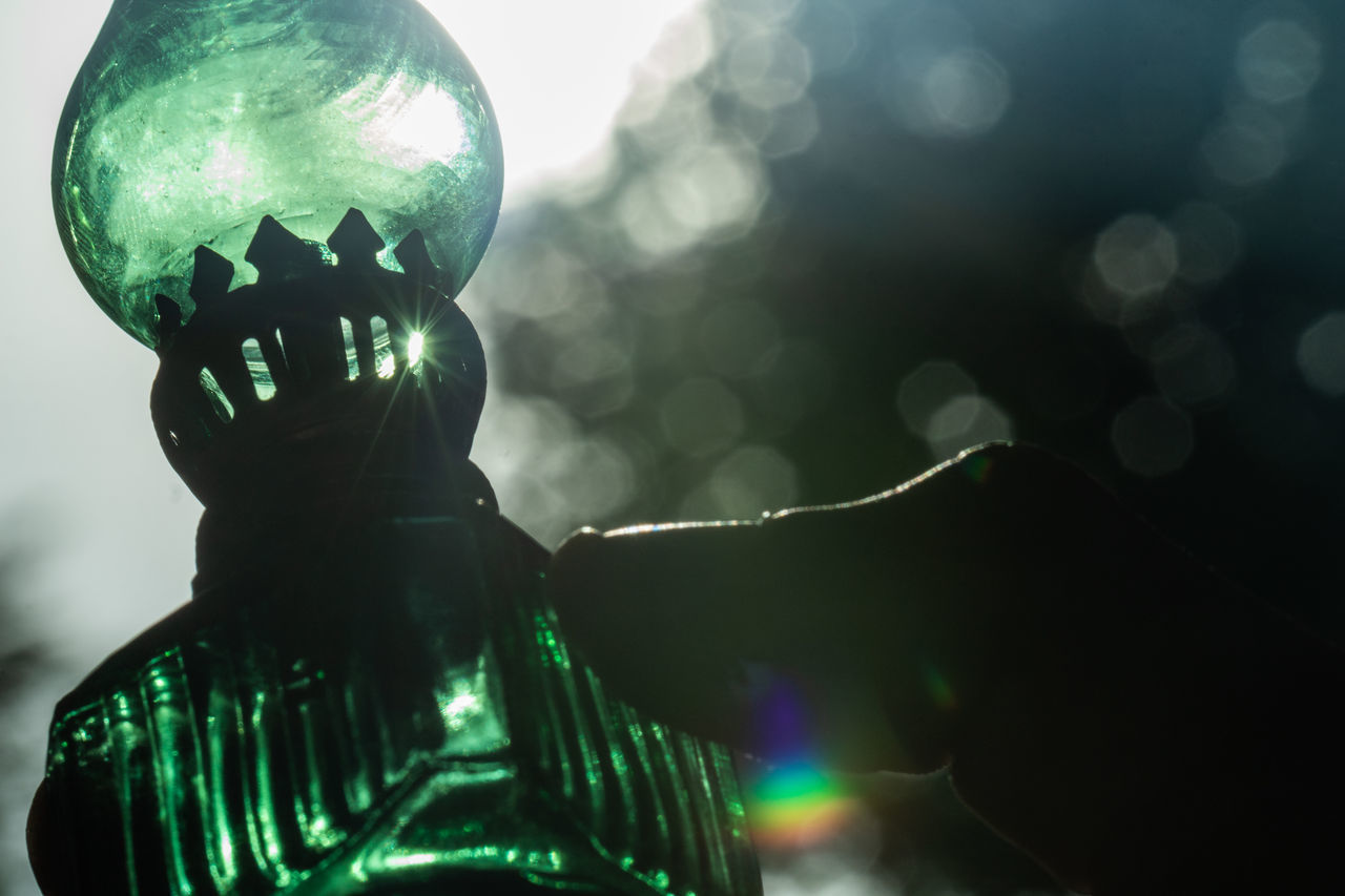 CLOSE-UP OF ILLUMINATED SCULPTURE AGAINST BLURRED BACKGROUND