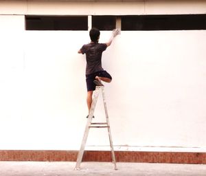 Full length of woman standing by railing