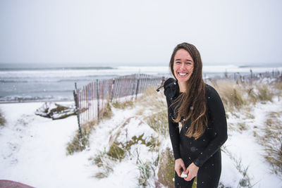 Woman laughing and going surfing in winter snow