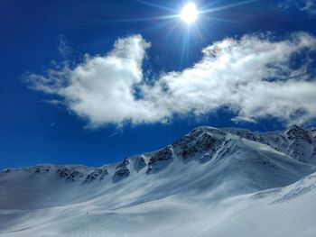 Low angle view of snowcapped mountains against sky