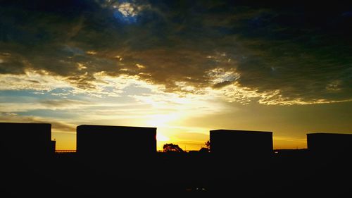 Silhouette of built structures at sunset