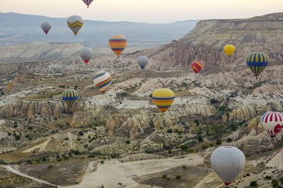 View of hot air balloons flying over rocks