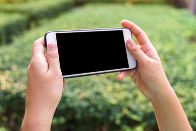 Midsection of person using mobile phone