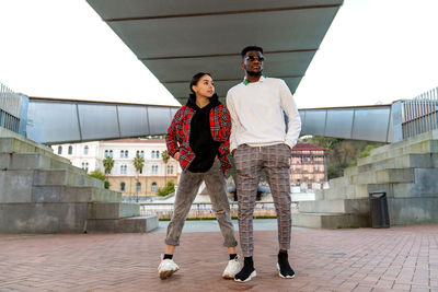 Full length of young couple standing outdoors