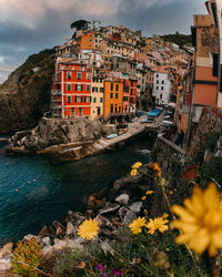 Scenic view of sea by buildings against sky