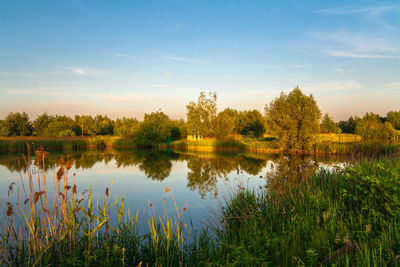 Scenic view of lake against sky at sunset