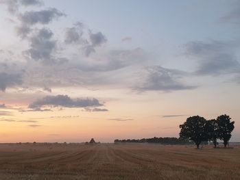 Scenic view of field against sky during sunset