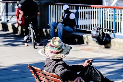 Man in sun hat sitting on bench