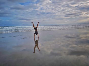 Handstand reflection on the beach