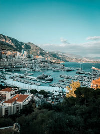 High angle view of townscape by sea against sky