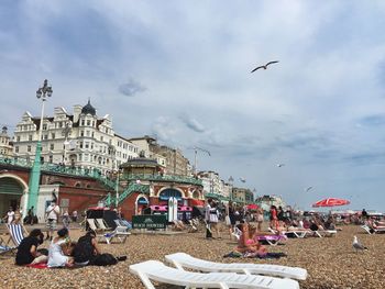 People on beach against sky