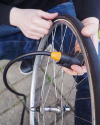 High angle view of man repairing bicycle wheel