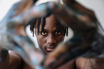 Artistic black man with painted hands