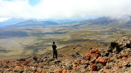 Rear view of man standing on mountain