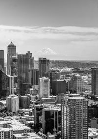 Tall buildings in downtown seattle, washington with mount rainier in the distance
