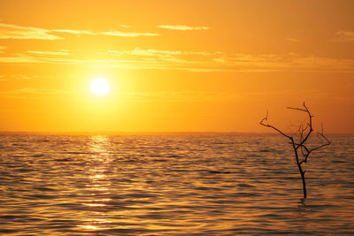 Scenic view of sea against romantic sky at sunset