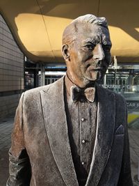 Midsection of man standing by sculpture