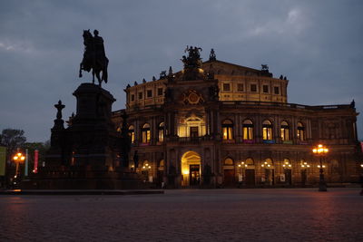 Statue in city at night