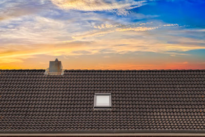 Buildings in city against sky during sunset