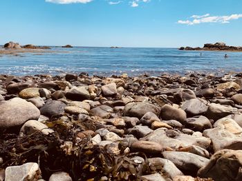 Rocks on beach against sky