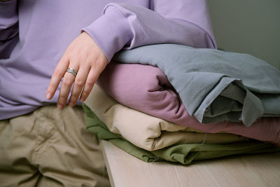 Midsection of woman resting on bed